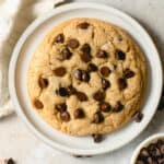 A single chocolate chip cookie on a small plate.