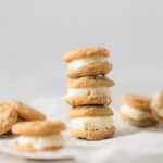 A stack of three small ice cream sandwiches filled with vanilla ice cream and surrounded by more sandwiches.