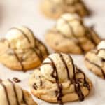 Chocolate chip cookies topped with vanilla mousse and a drizzle of chocolate sauce.