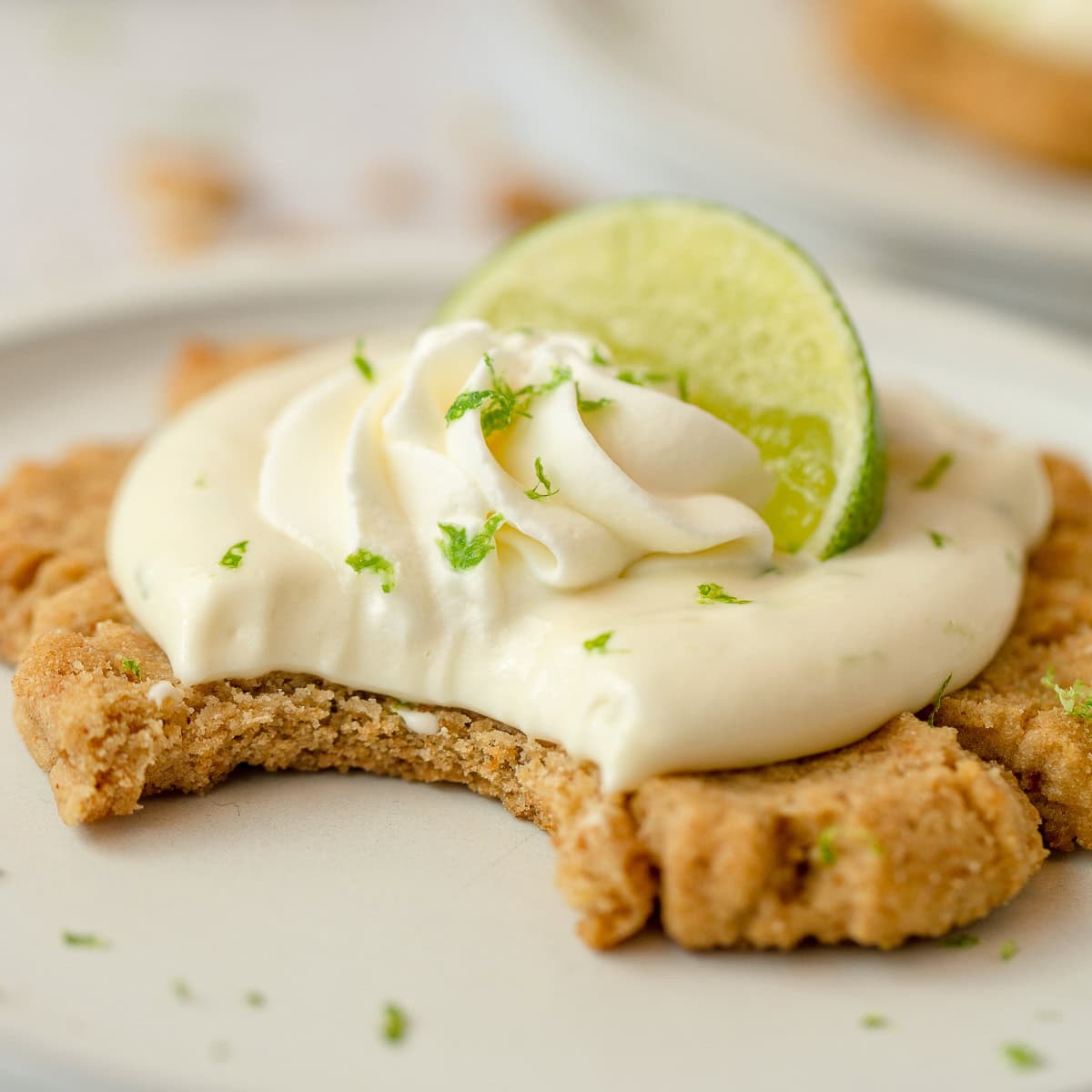 A key lime pie cookie with a bite removed.