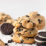 A stack of three peanut butter & chocolate sandwich cookie cookies surrounded by more chocolate sandwich cookies.