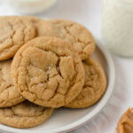 A plate of peanut butter cookies with flaked sea salt sprinkled on top.