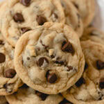 A small pile of several egg-free chocolate chip cookies.