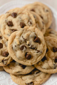 A small pile of several egg-free chocolate chip cookies.