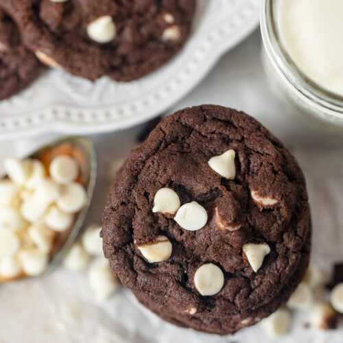 A stack of chocolate cookies with white chips.