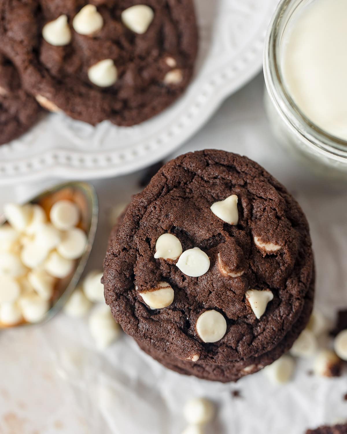 A stack of chocolate cookies with white chips.