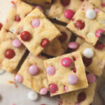 Valentine's Day sugar cookie bars cut and arranged on parchment.