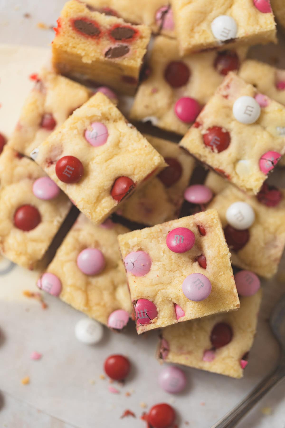 Valentine's Day sugar cookie bars cut and arranged on parchment.