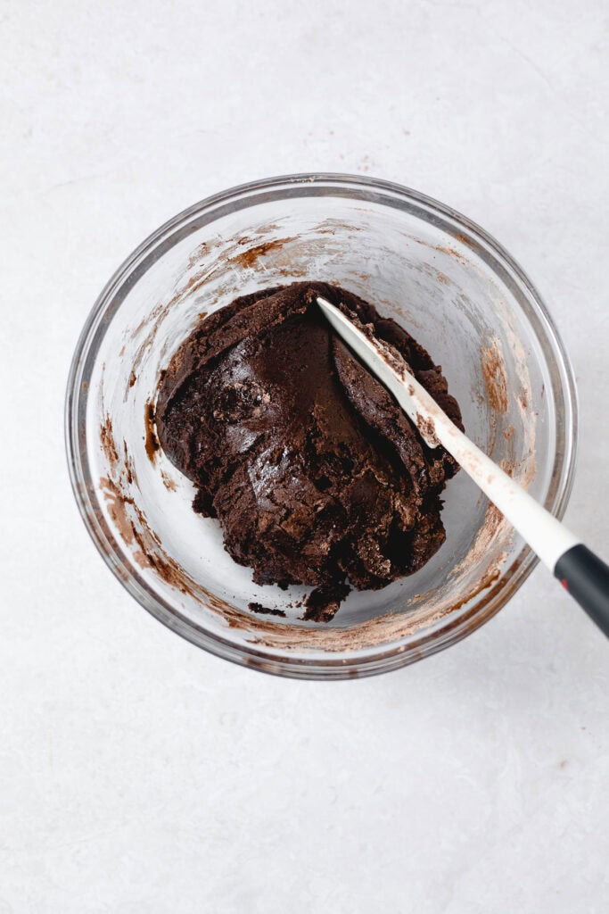 Brownie cookie dough from a brownie mix in glass bowl.