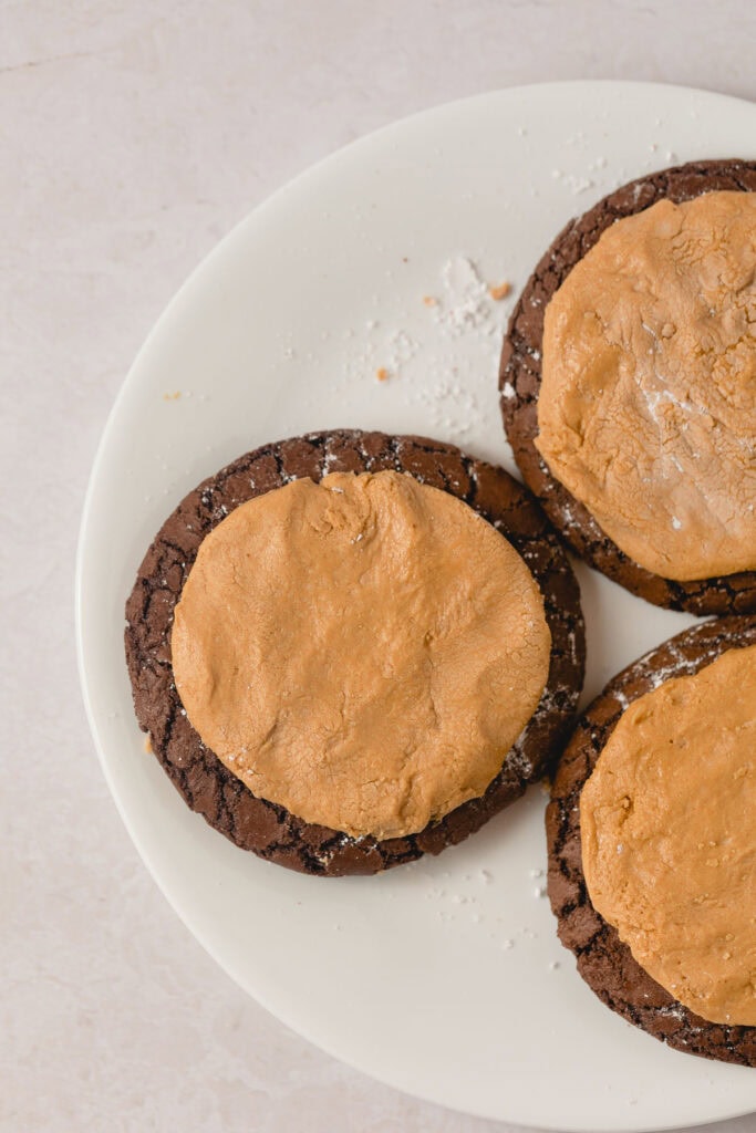 Brownie cookies with disks of peanut butter filling pressed on top.
