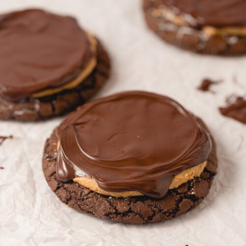 Crackly brownie cookies covered with peanut butter filling and melted chocolate ganache.