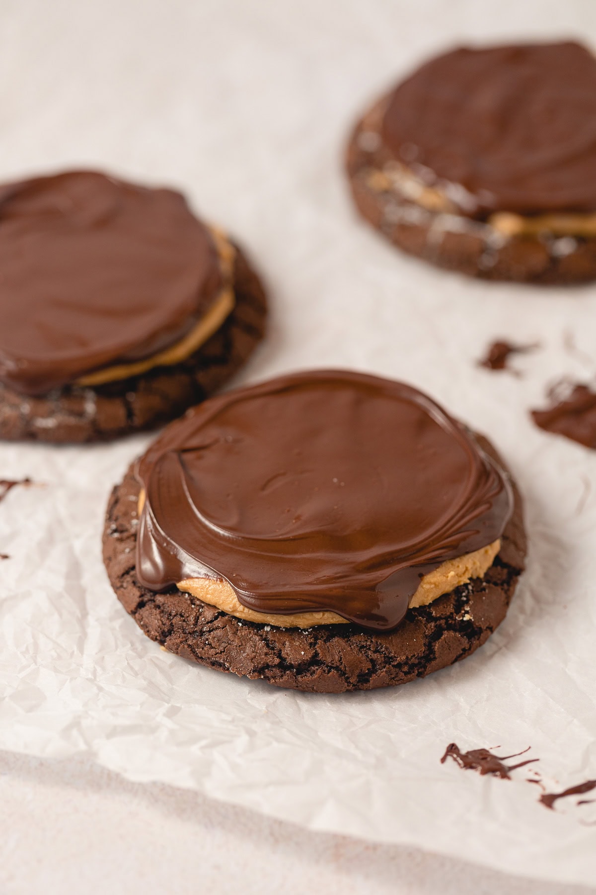 Crackly brownie cookies covered with peanut butter filling and melted chocolate ganache.