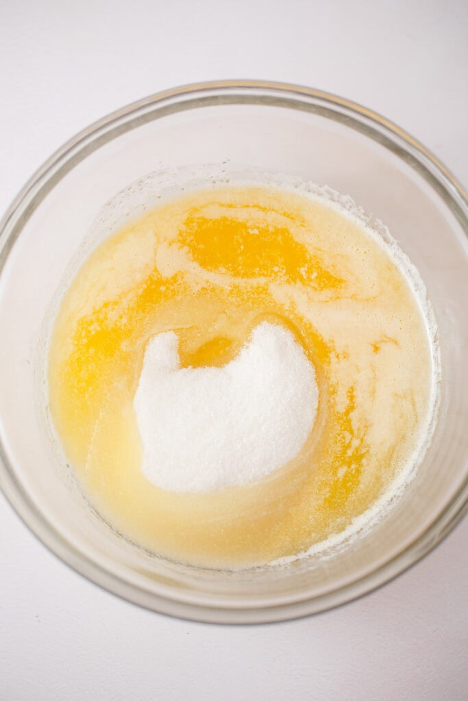 A bowl of sugar and melted butter.