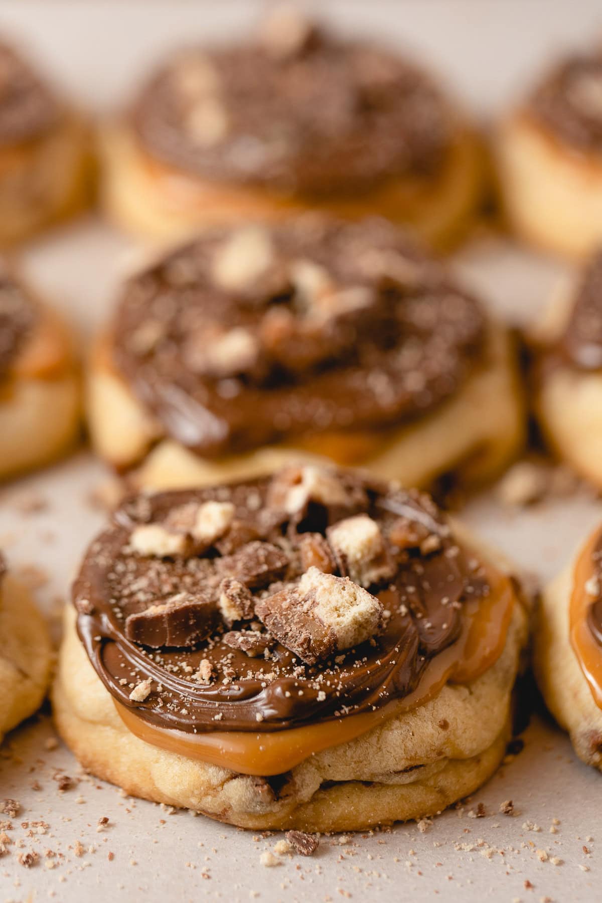Caramel shortbread cookies decorated with chopped candy bars.