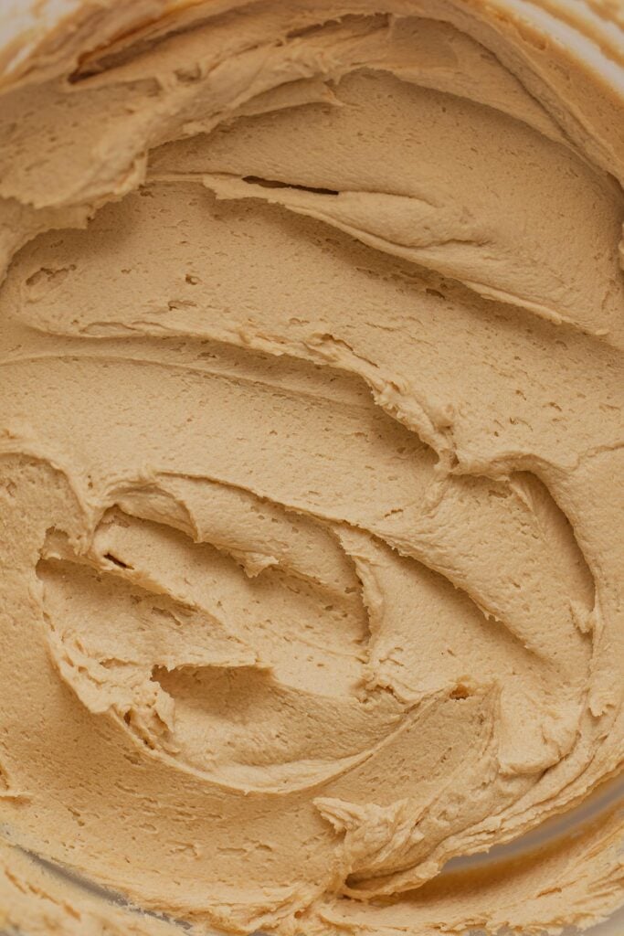 Peanut butter frosting swirled in a bowl.