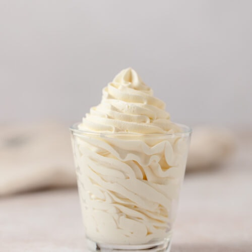 Piped soft yellow banana mousse in a glass.