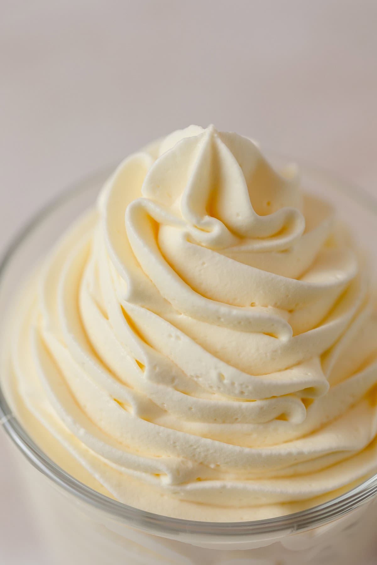 Piped swirls of soft yellow banana whipped cream.