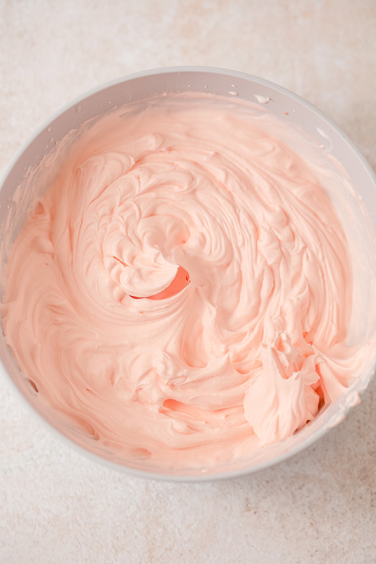 Swirled pink strawberry mousse in a bowl.