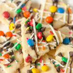 Sugar cookie "nachos" topped with drizzles of chocolate and mini chocolate candies in a variety of colors.