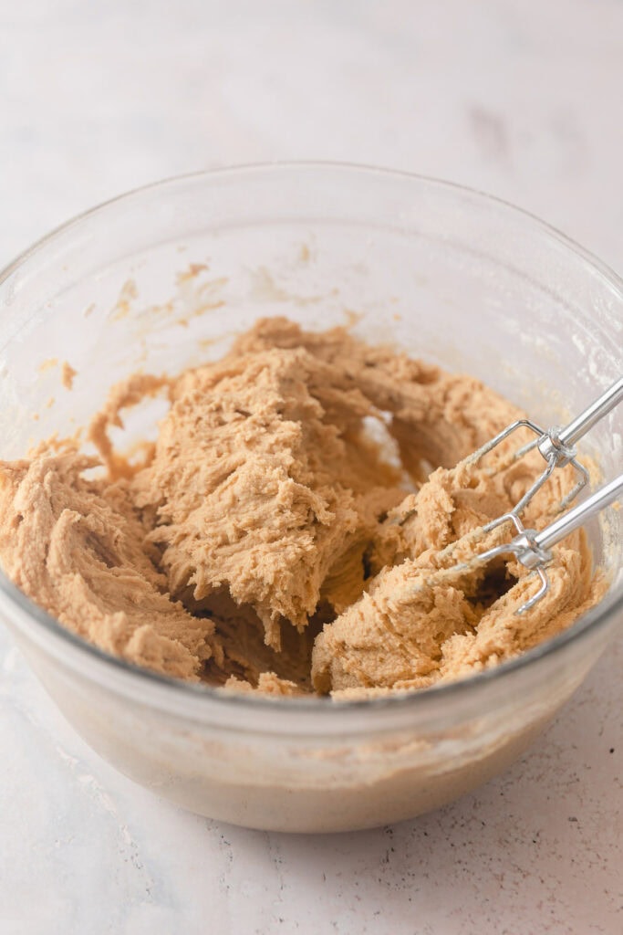 A bowl of peanut butter cookie dough with the beaters.