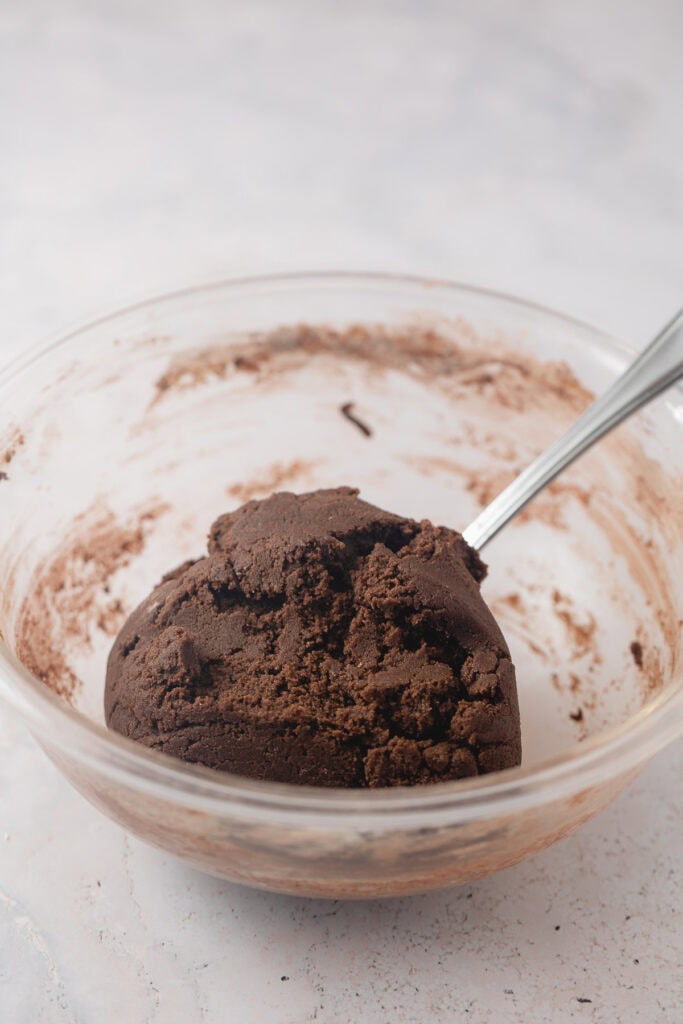 A glass bowl of chocolate cookie dough.