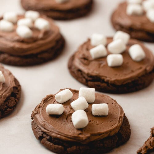 A tray of chocolate cookies frosted with chocolate frosting and mini marshmallows.