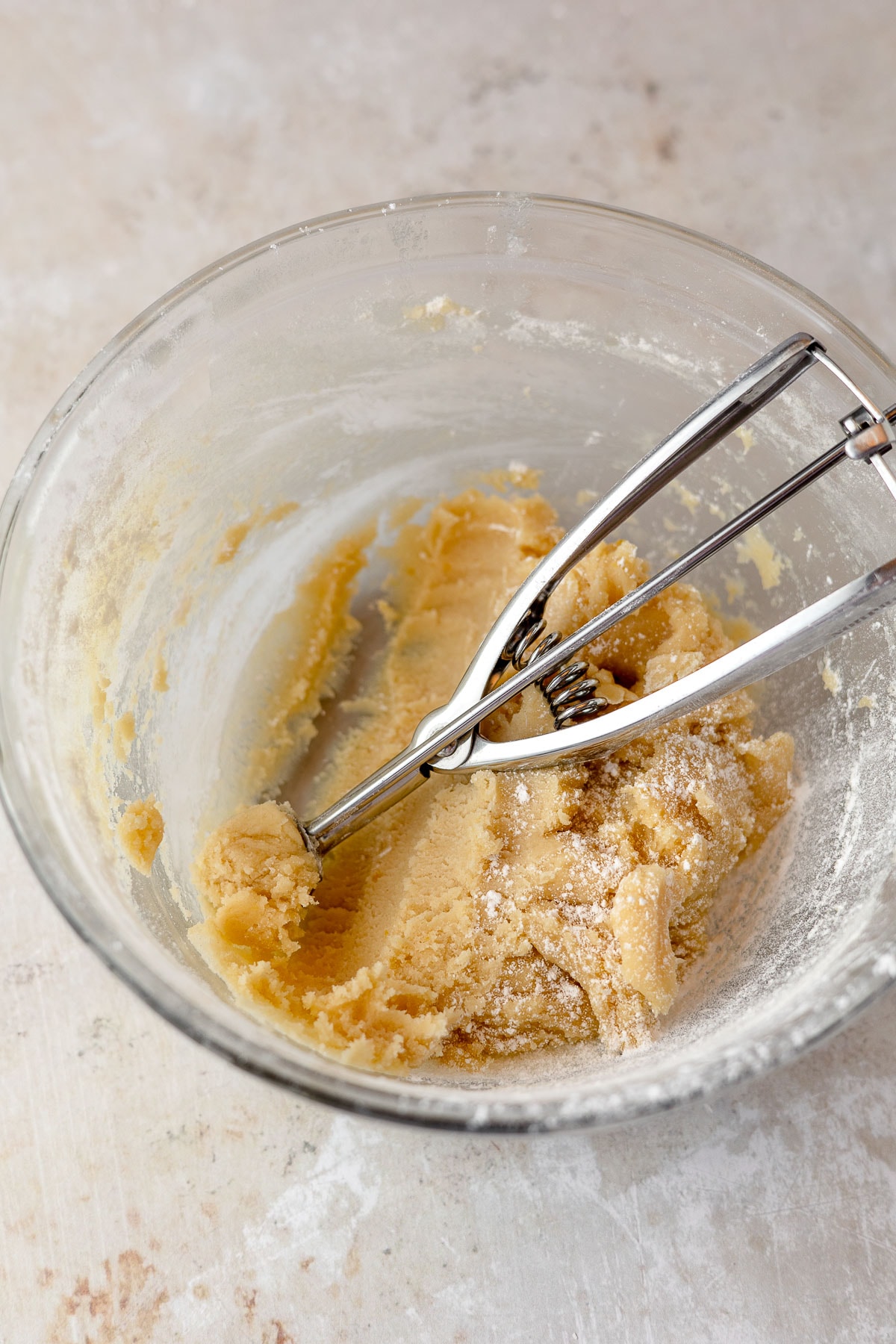 A bowl of cookie dough with a mini 1-teaspoon scoop.