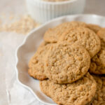 A white plate filled with homemade oatmeal peanut butter cookies.