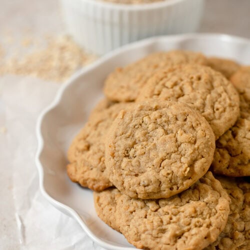 A white plate filled with homemade oatmeal peanut butter cookies.